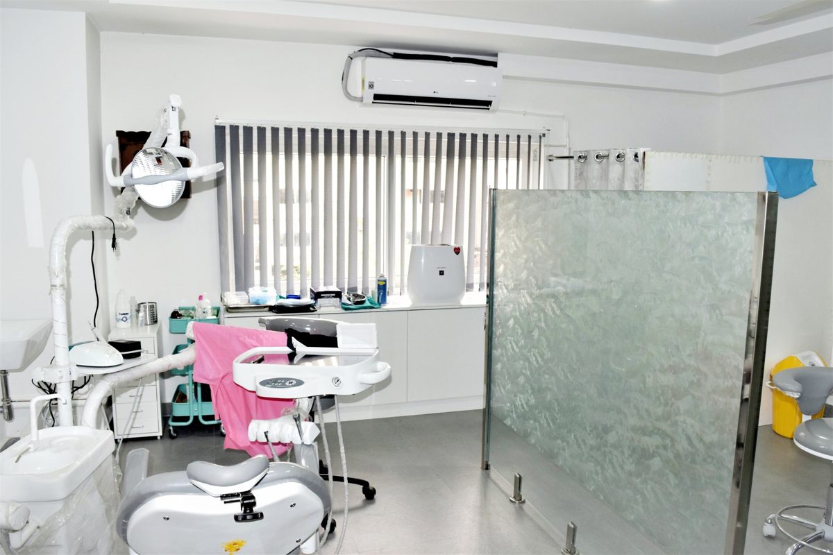 Dental treatment room with chair and overhead light