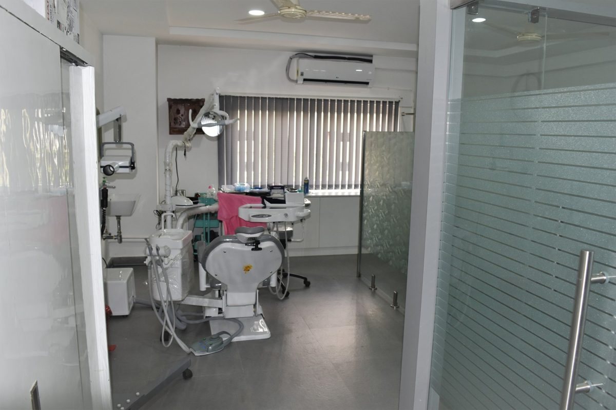 A treatment room at Align Dental seen past the frosted glass partition, chair prepared