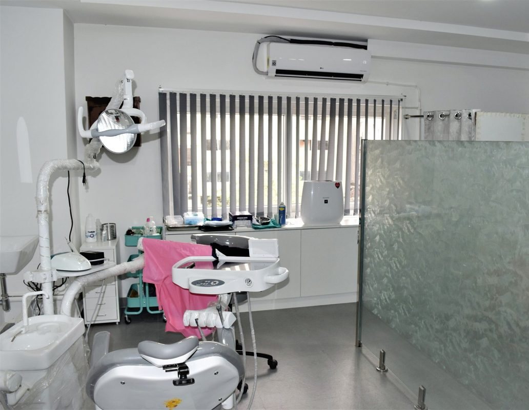 A dental chair draped and prepared at Align Dental, with the blinds drawn behind