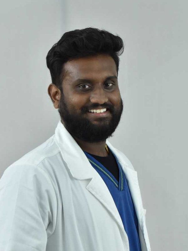 Dr. Challa Surya Venkata Sairam in a white coat