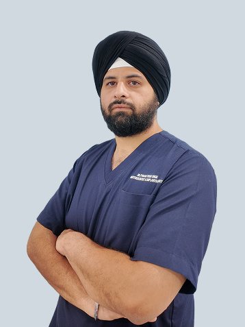 Dr. Paramveer Singh Malik in navy scrubs